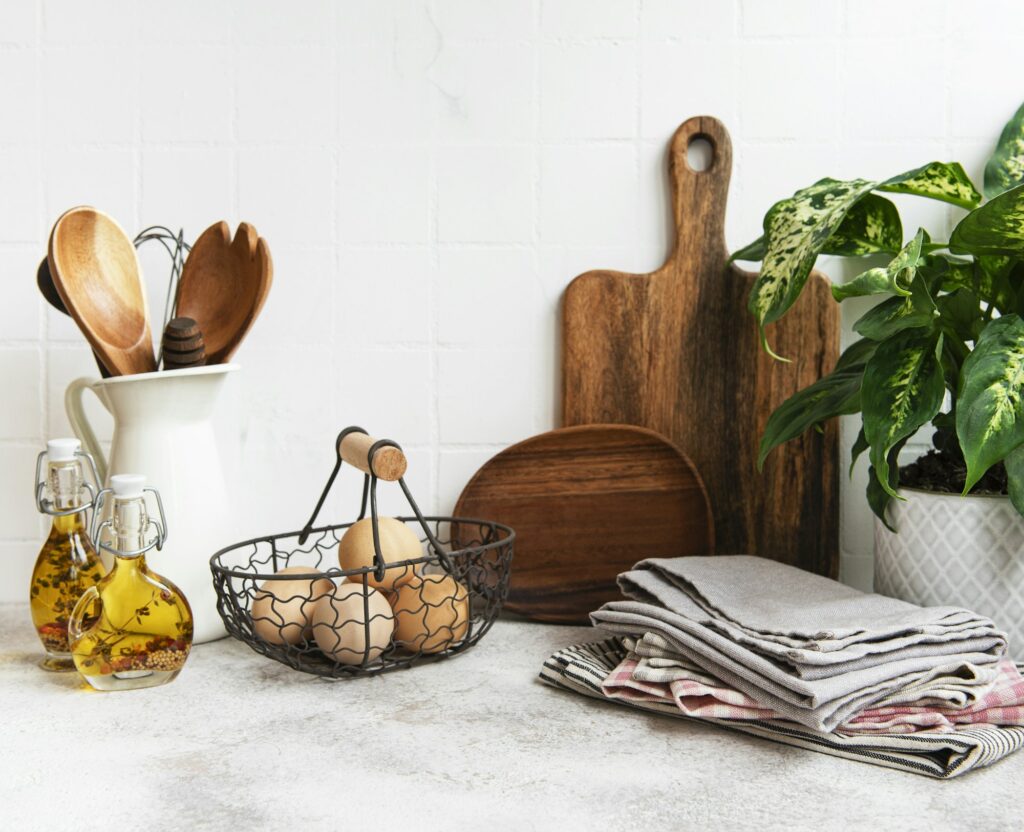 Kitchen utensils, tools and dishware on on the background white tile wall.